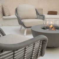 Ronde grijze bio-ethanol vuurtafel met bronzen glaskiezels en windscherm